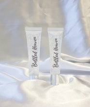 Load image into Gallery viewer, two clear Cloud 9 lip glosses on white satin fabric
